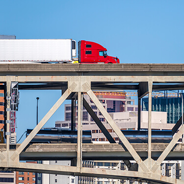 Red freight semi truck on bridge Intra-Mexico Freight Shipping