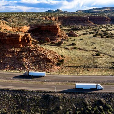 Cross Border Shipping from or To New Mexico Aerial view highway with semi trucks