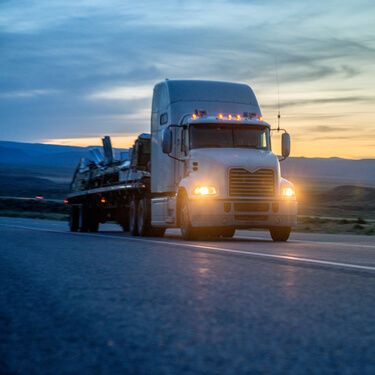 Nogales Cross Border Shipping White Flatbed Semi Truck on Highway